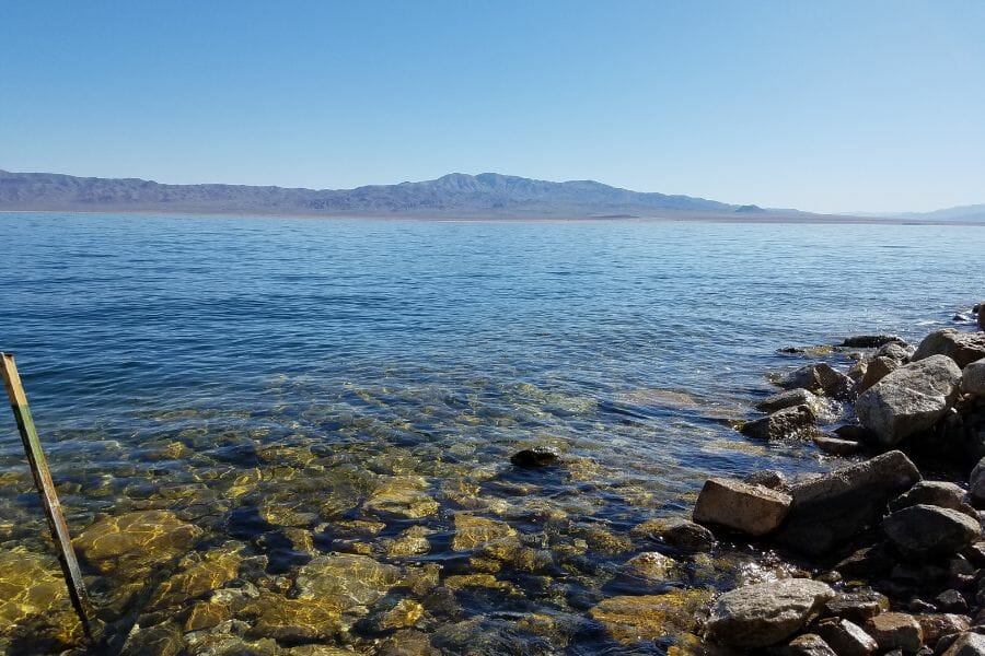 rocky lake shore with a mountain in the background