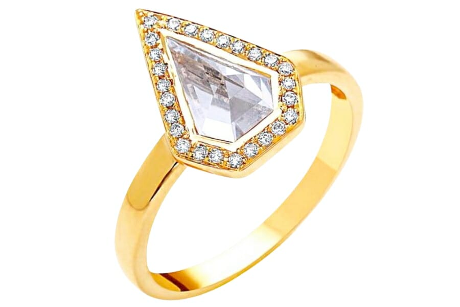 A gold ring encrusted with sparkling white topaz