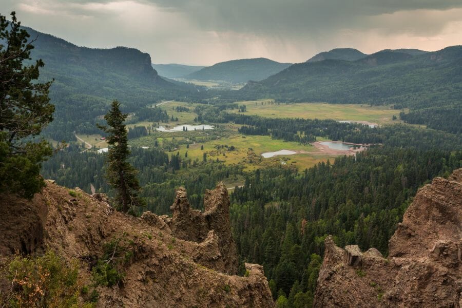 view of green mountains, plains, and trees from Wolf Creek Pass