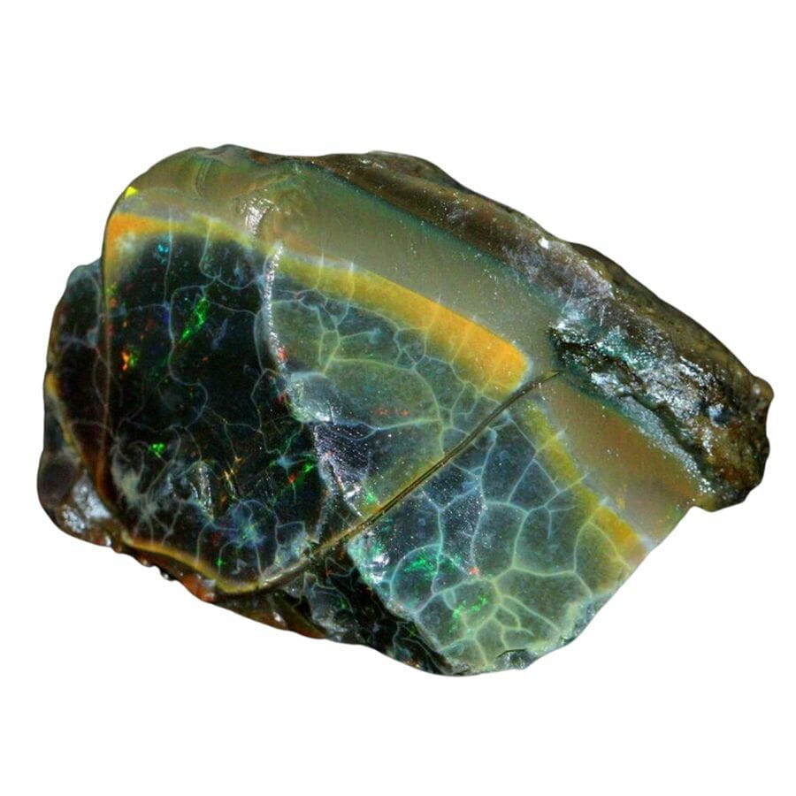 raw black opal with bright green, orange and yellow flecks
