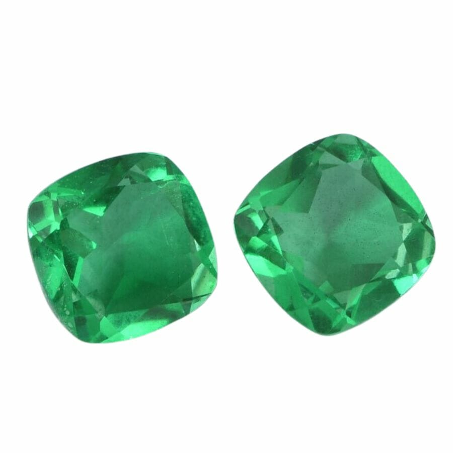 two green cushion cut doublet emeralds