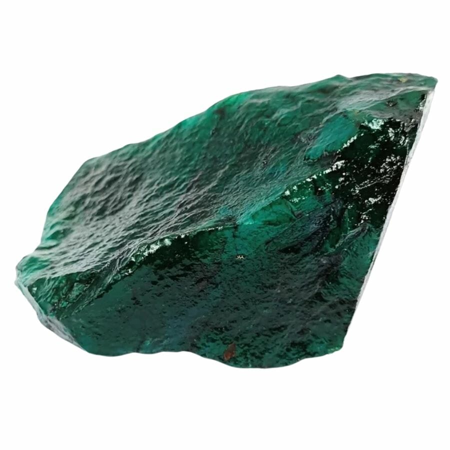 deep green emerald crystal shard showing imperfect cleavage