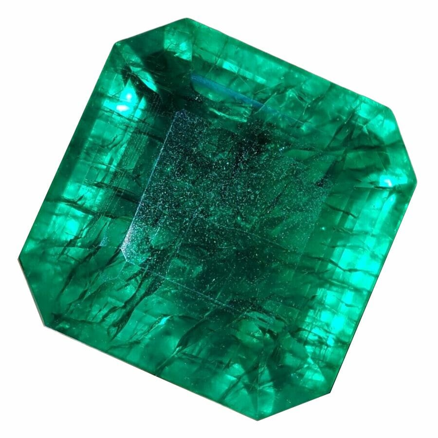 square deep green octagonal emerald with darker inclusions