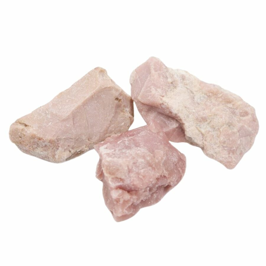 three pieces of pink raw talc
