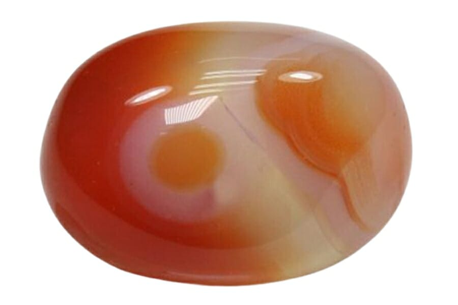 A stunning polished and tumbled agate gemstone with orange hues