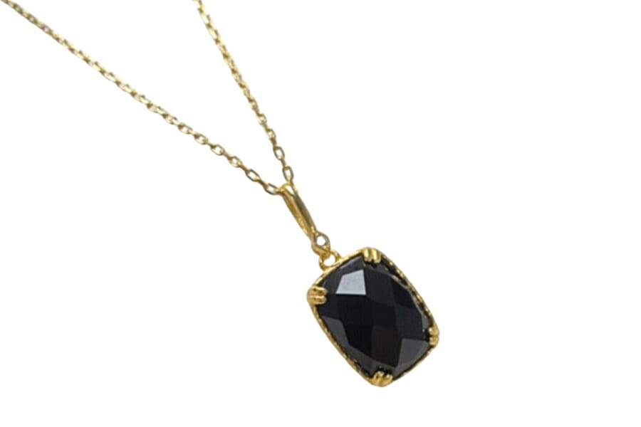 An exquisite black carnelian pendant on a gold chain