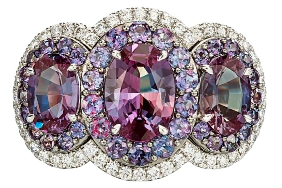 Three oval-shaped Brazilian alexandrite set on a platinum ring and surrounded by diamonds