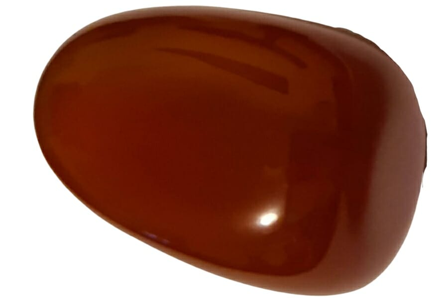 A shiny polished tumbled brown carnelian