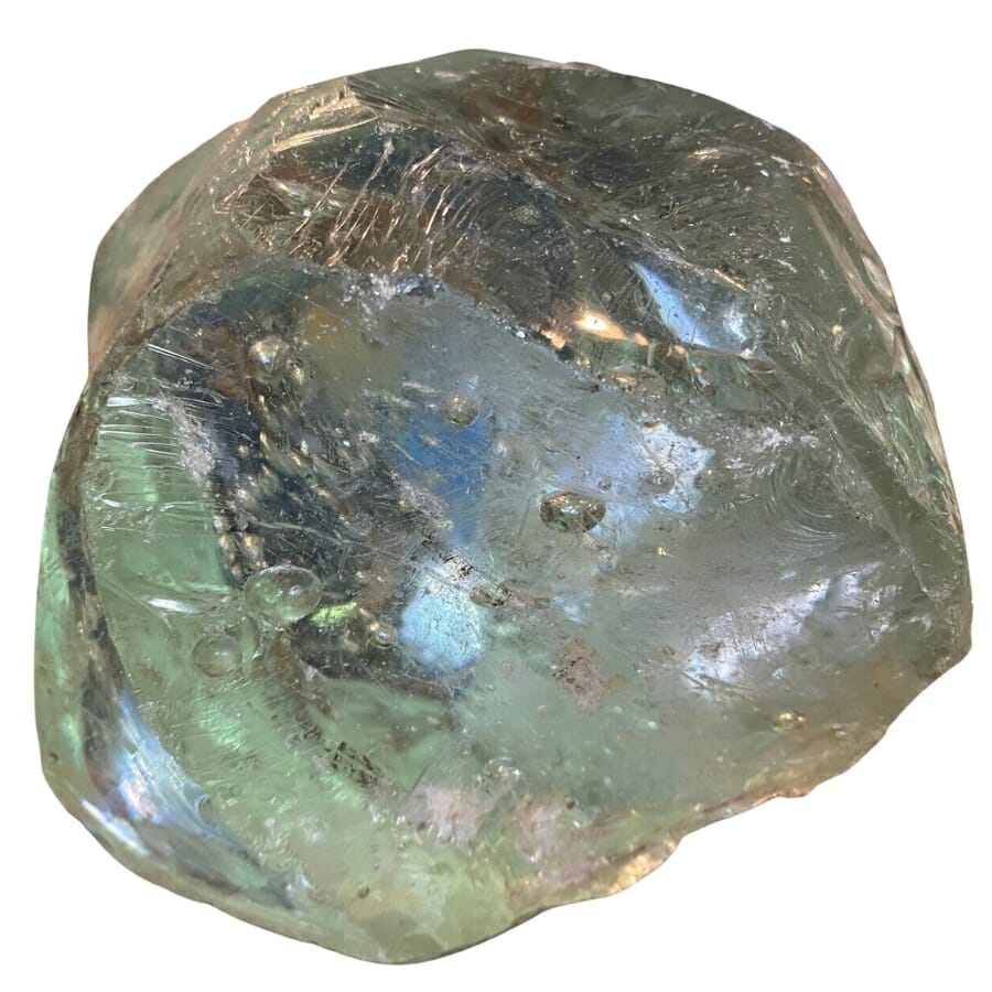 A raw glass crystal with bubble-like inclusions