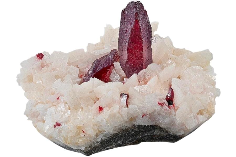 A deep red cinnabar crystal with visible inclusions on white dolomite