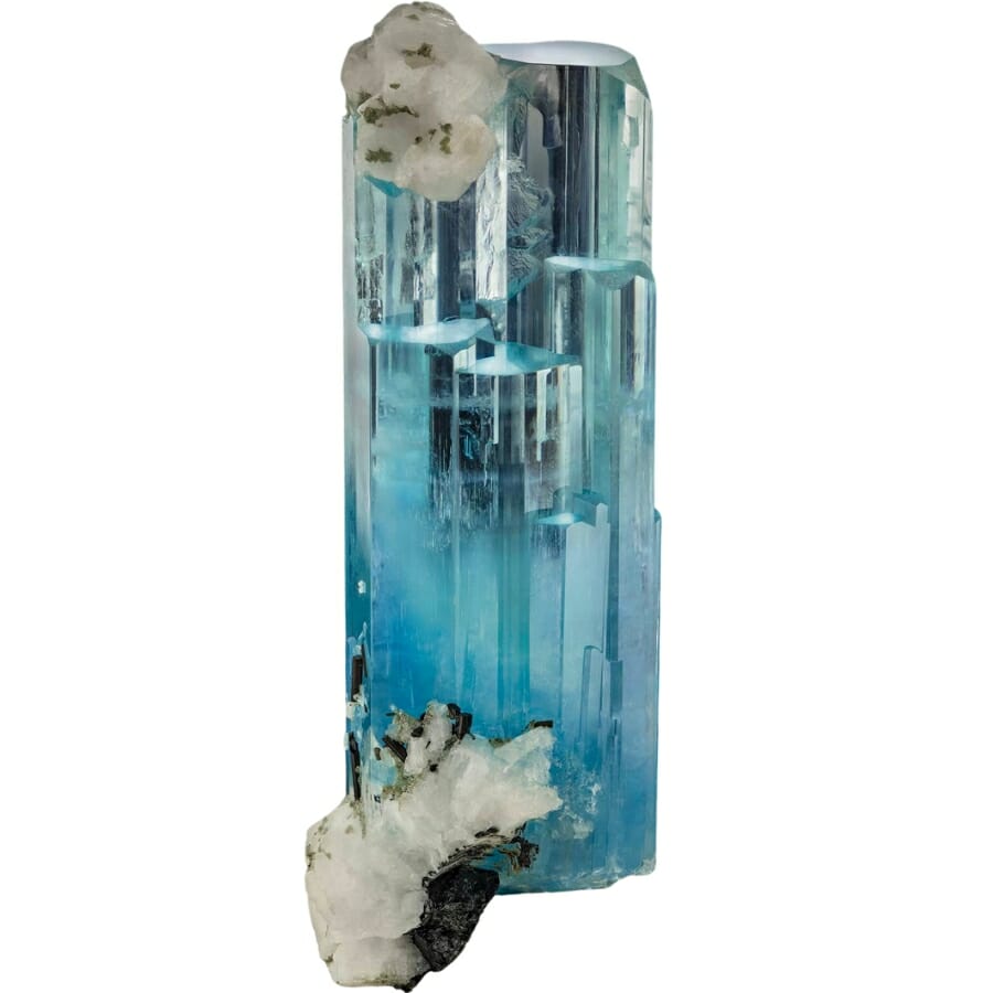 A raw aquamarine with schorl on albite