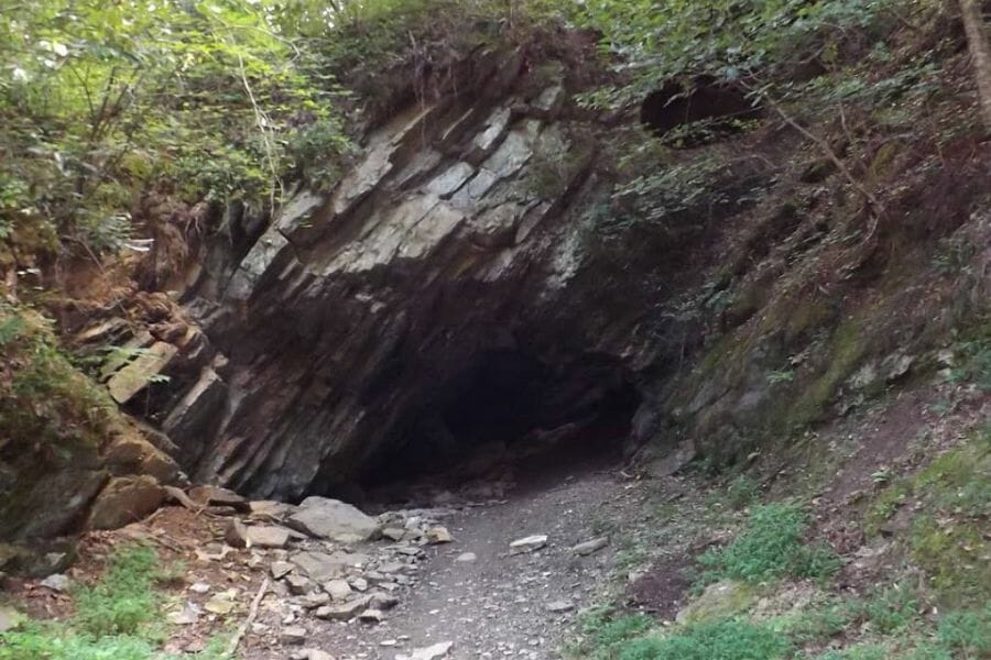 hole in a mountain face, the entrance to Little Pine Garnet Mine