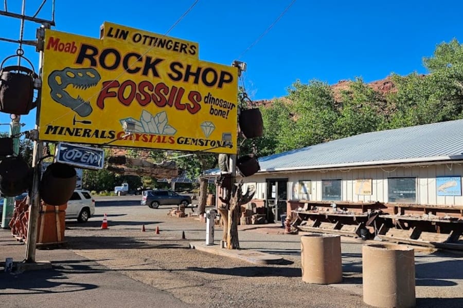 A look at the signage of Moab Rock Shop advertising its dinosaur bone fossils in front of its store