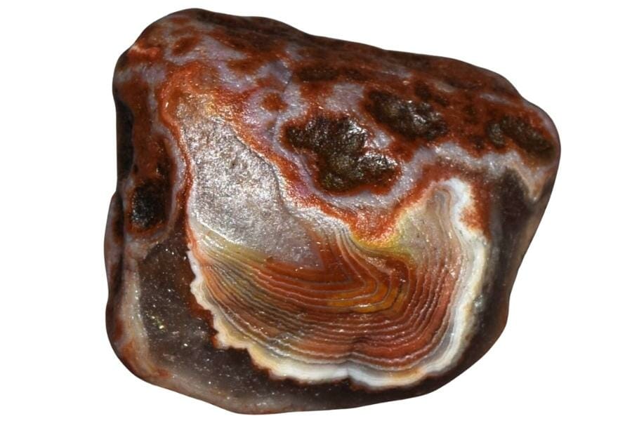 A smooth and shiny natural agate specimen with red and orange hues