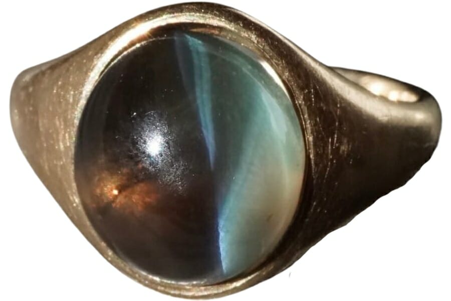 A Sri Lankan alexandrite cabochon with strong cat-eye effect set on a gold ring