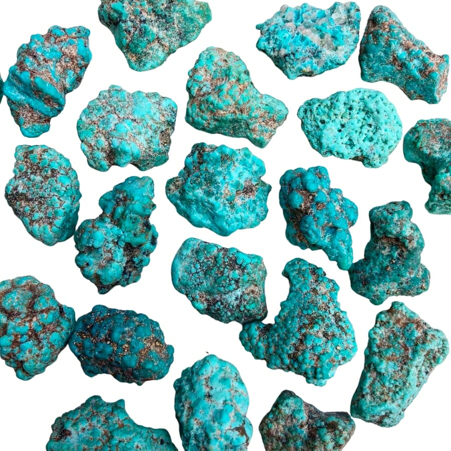 Raw turquoise rocks on white background