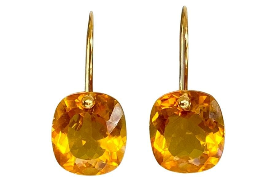 A pair of dangling earrings with sparkling yellow topaz