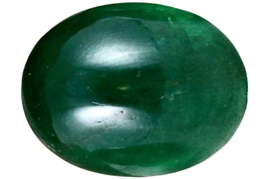 A gorgeous dark green oval-shaped Zambian emerald gemstone