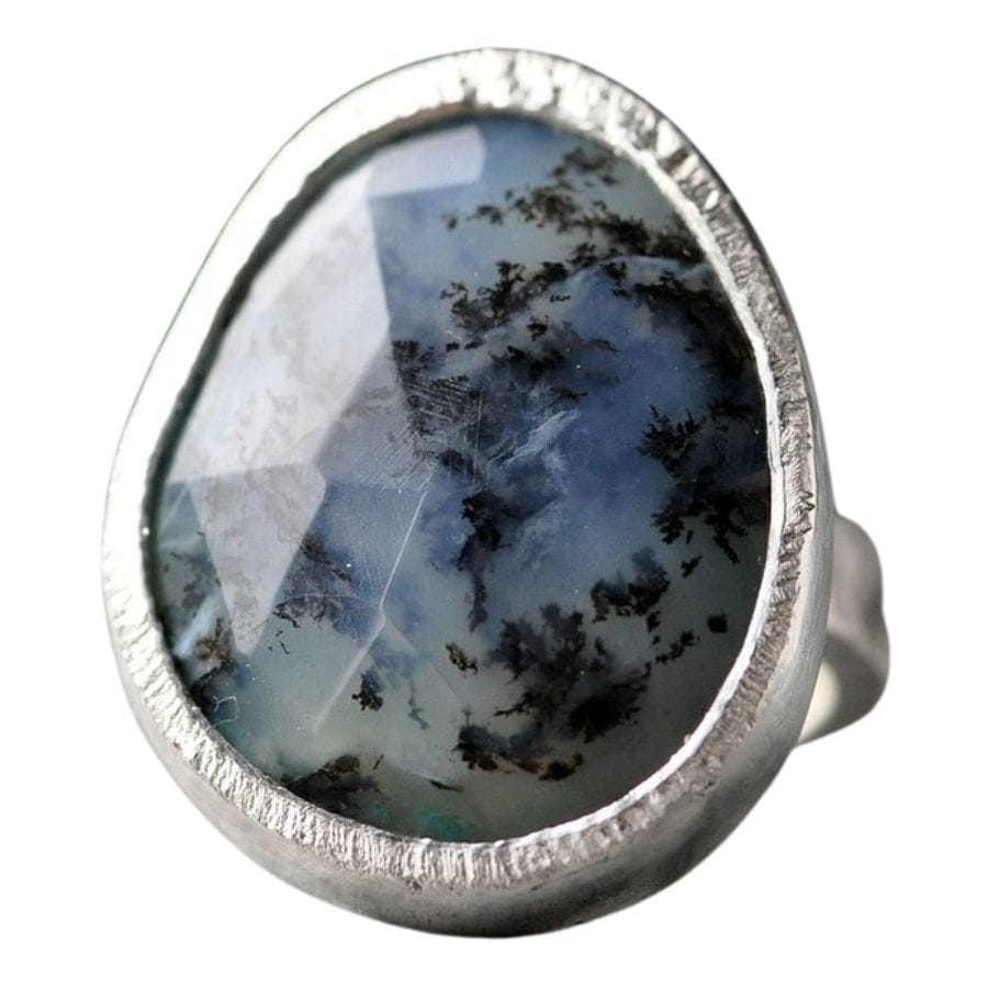 blue faceted dendritic opal set in a silver ring