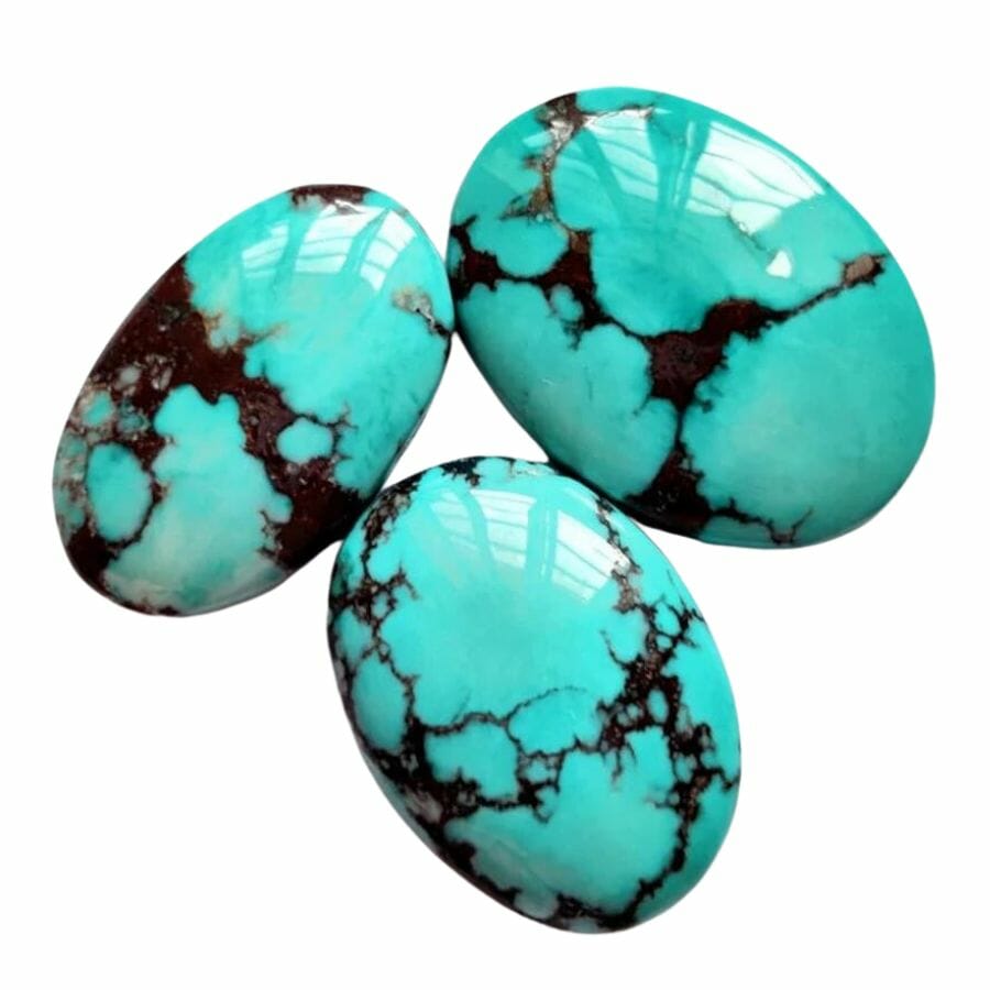 three polished oval dyed magnesite that are blue-green in color