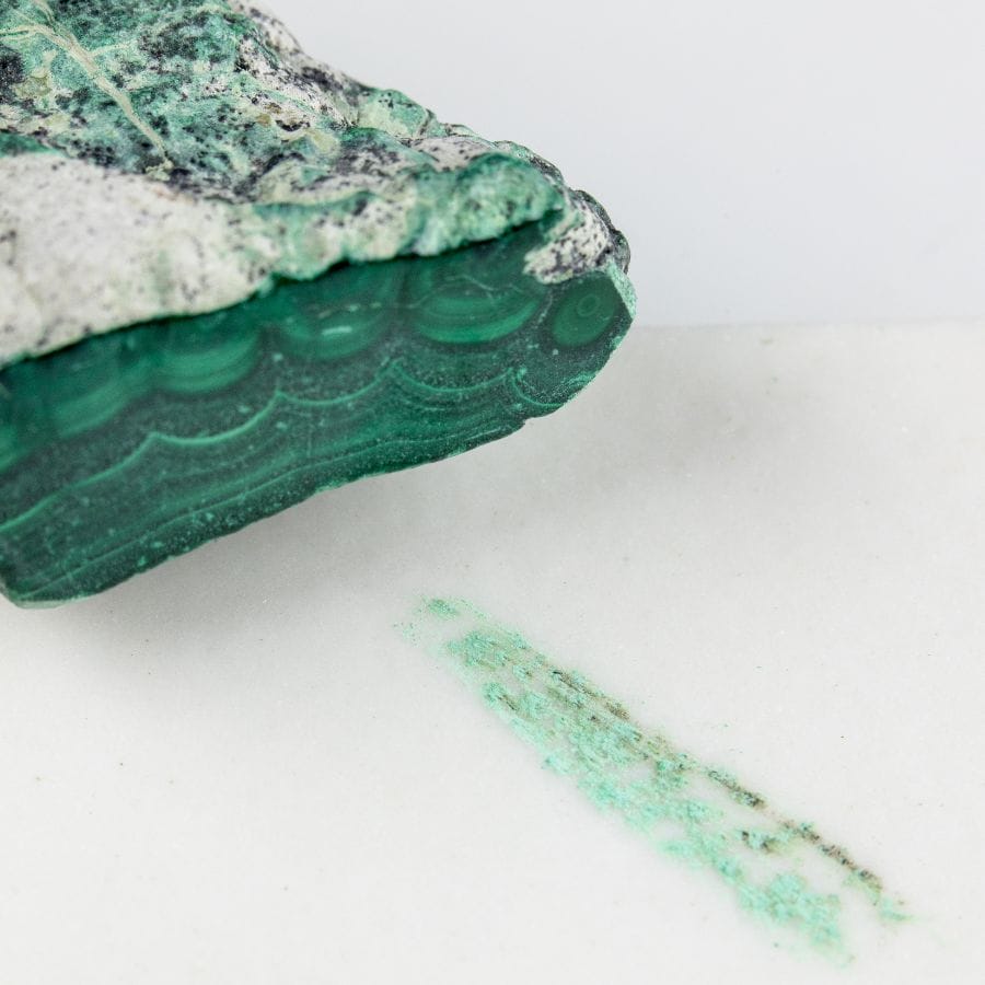malachite with streak plate showing the stone's green streak