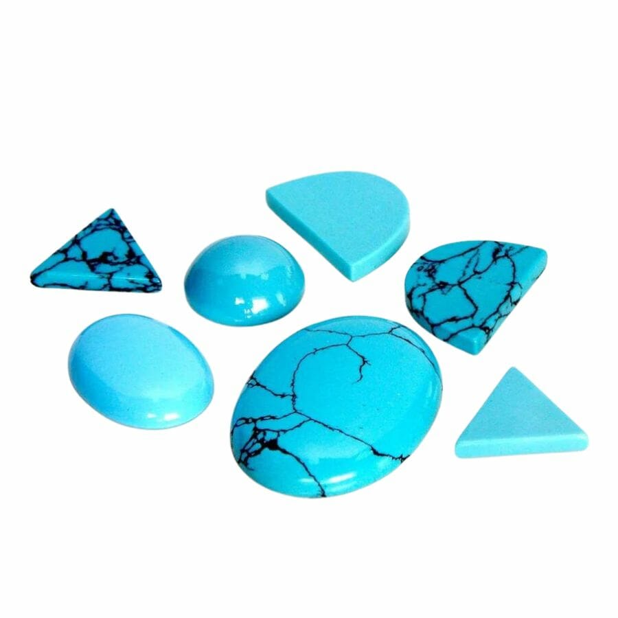 seven pieces of bright sky blue resin turquoise cabochons, shaped like triangles, circles, ovals, and half-circles