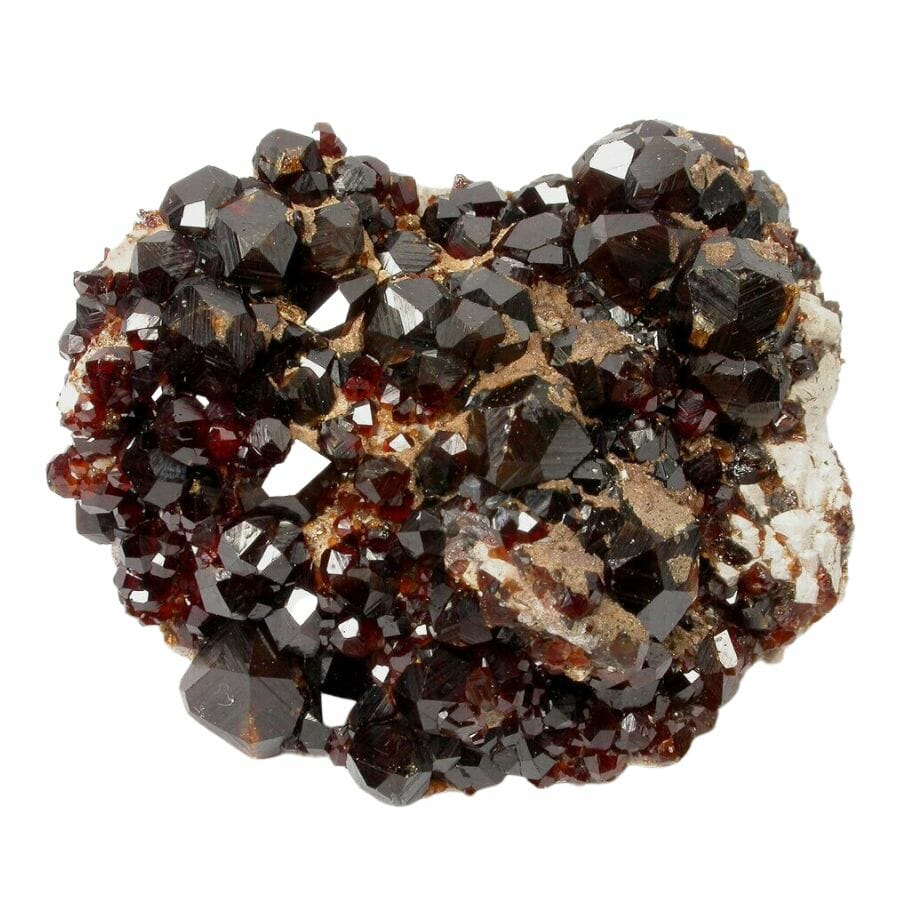 dark red spessartine garnet crystal cluster on a rock
