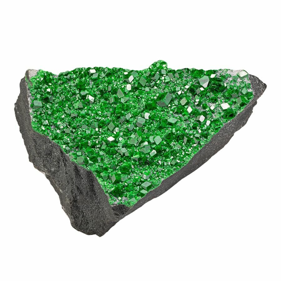 bright green uvarovite garnet crystals on a rock