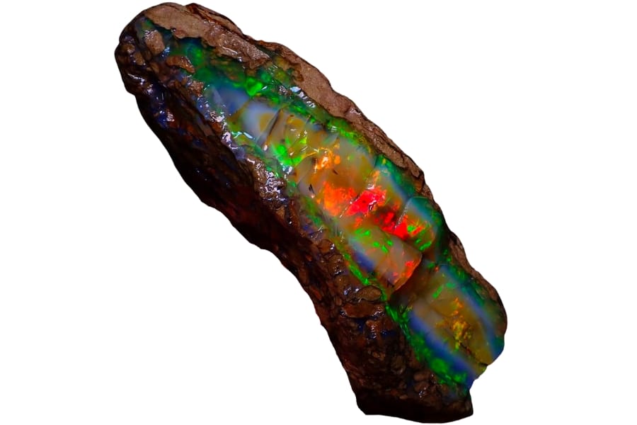 A large piece of opal crystal showing vibrant green, blue, and orange colors