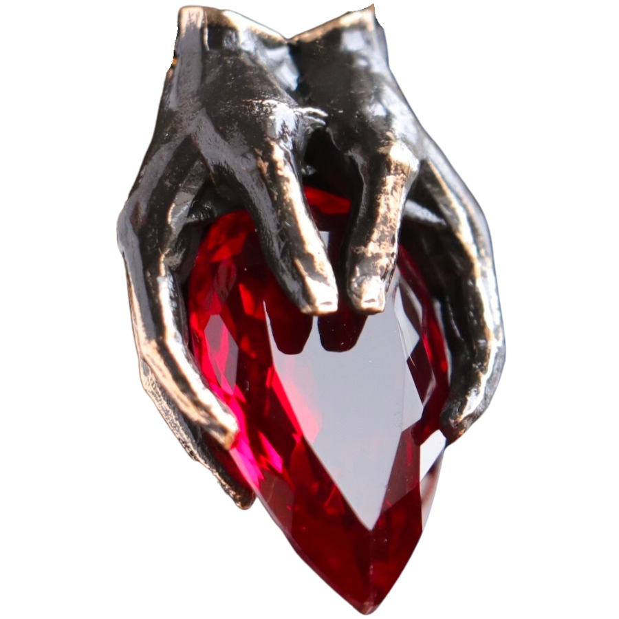 A pendant with a heart-shaped red garnet held by hands made of bronze