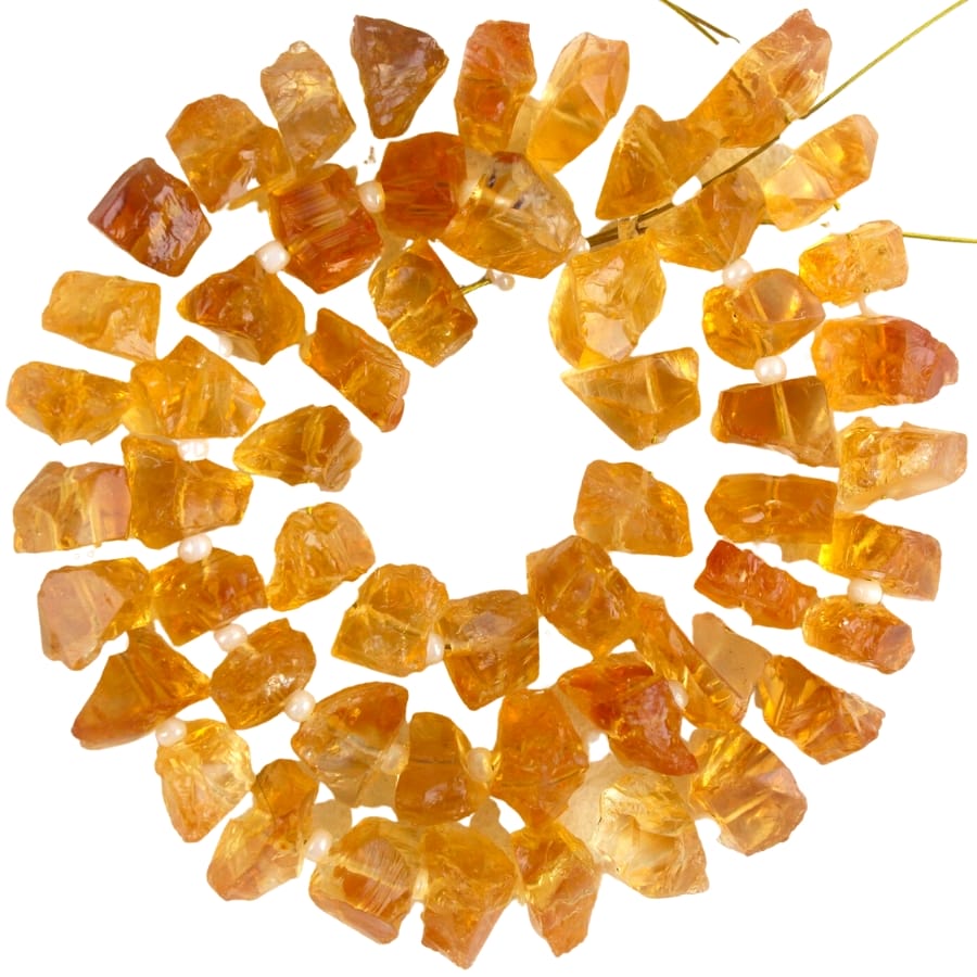 Fifty pieces of raw and rough citrine with amber orange color