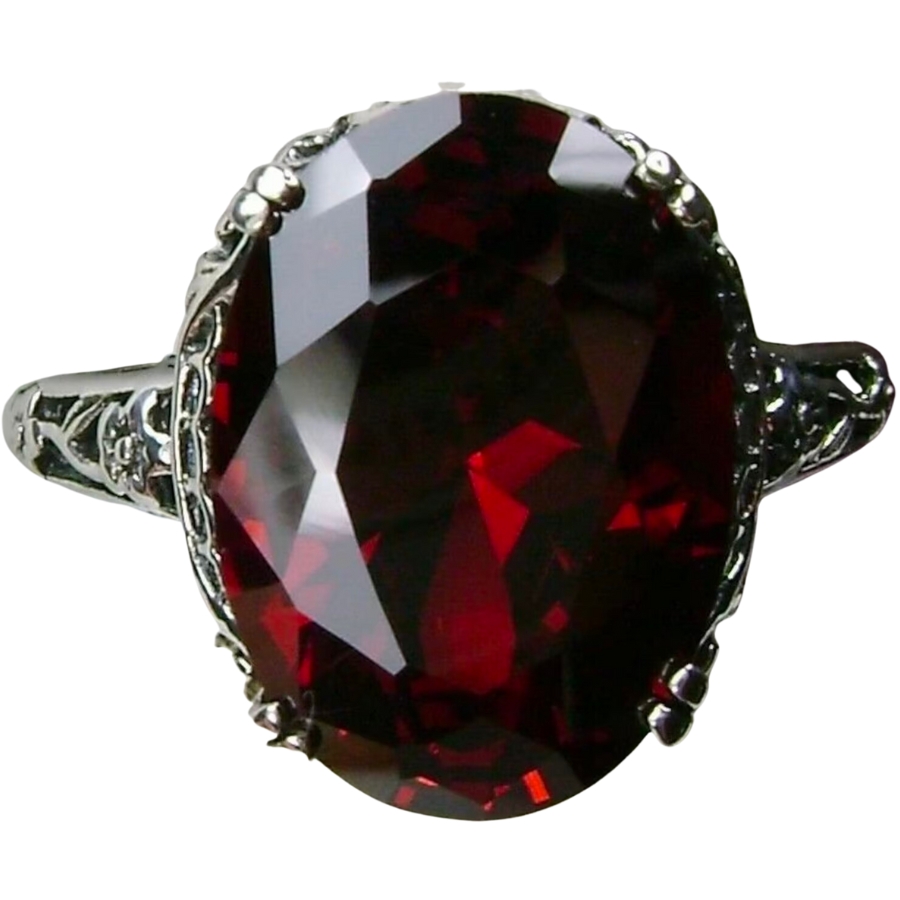 A silver ring adorned with a deep red garnet as center stone