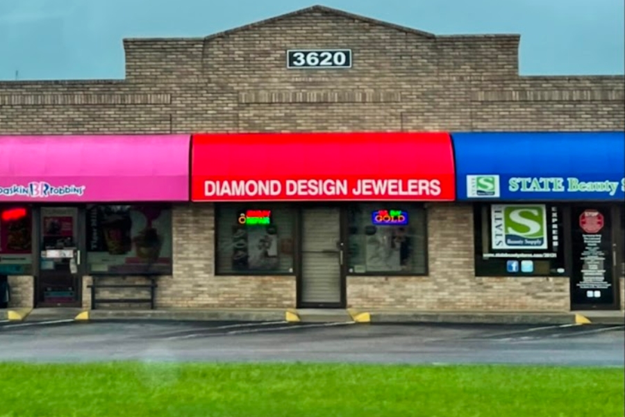 A peak at the front store window and building of the Diamond Design Jewelers