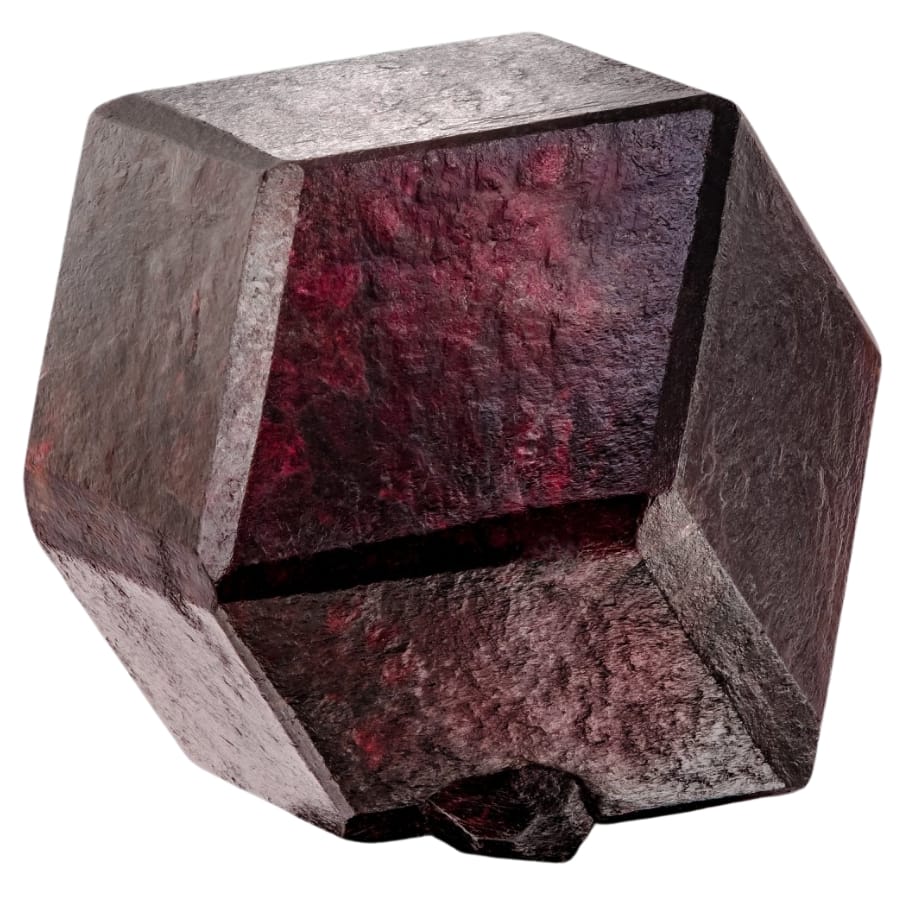 A perfect hexagonal shaped garnet gemstone with a distinct texture