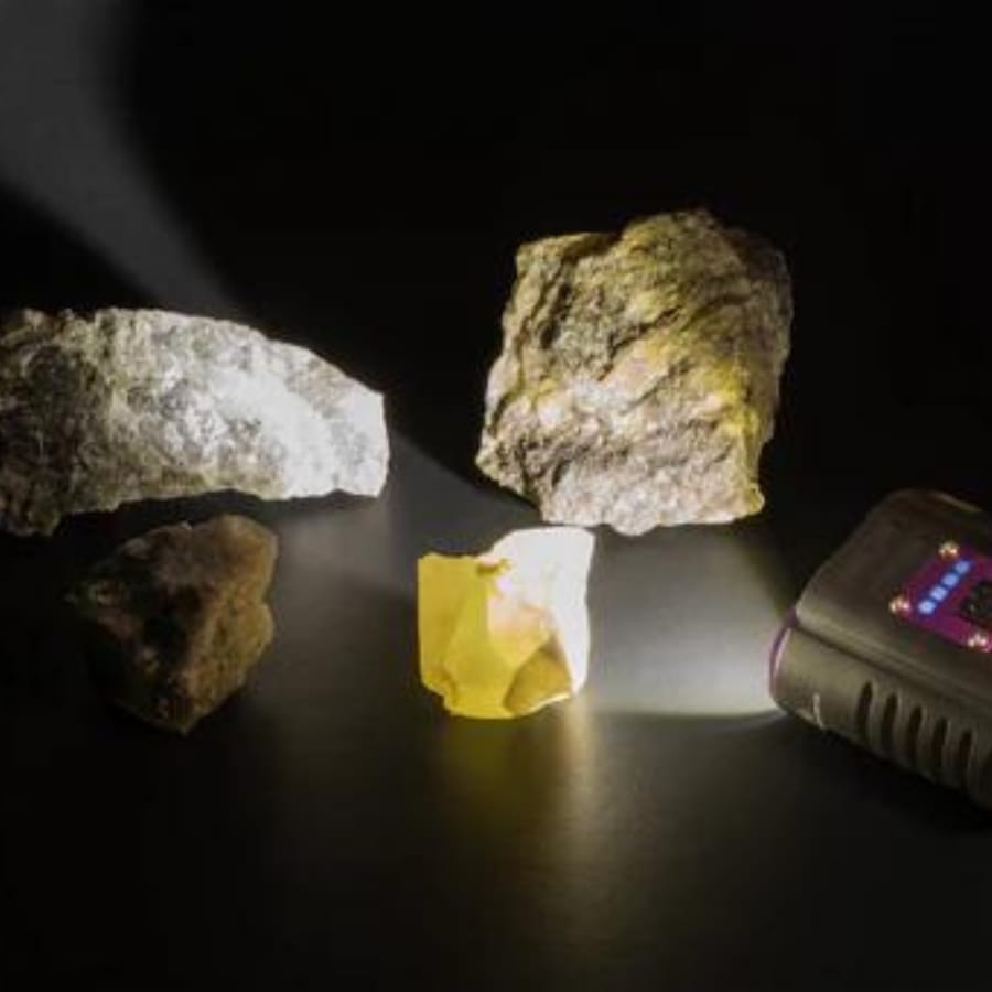 Shining a flashlight on the rocks and minerals