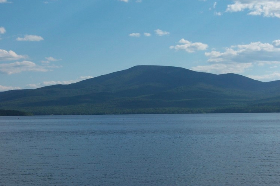 A wide view of the stretch of the Lyon Mountain foregrounded by vast waters