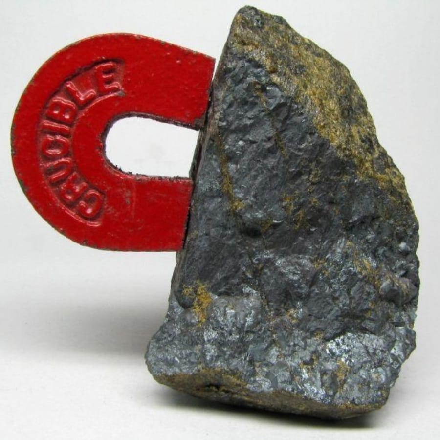 A magnet clinging on to a mineral or a rock
