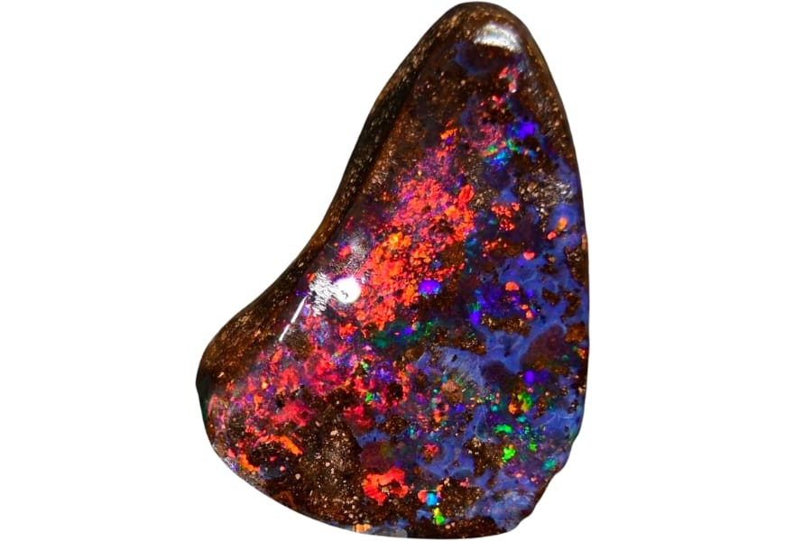 A beautiful cut and polished opal boulder with flashes of pink, orange and blue hues and strikes of occasional purple and green