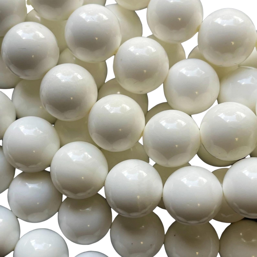 A handful of white tiny and round shell pearls