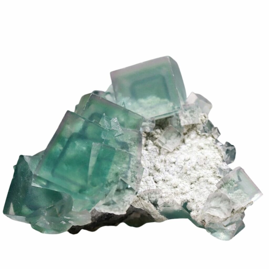perfectly cubic translucent green fluorite crystals on a rock