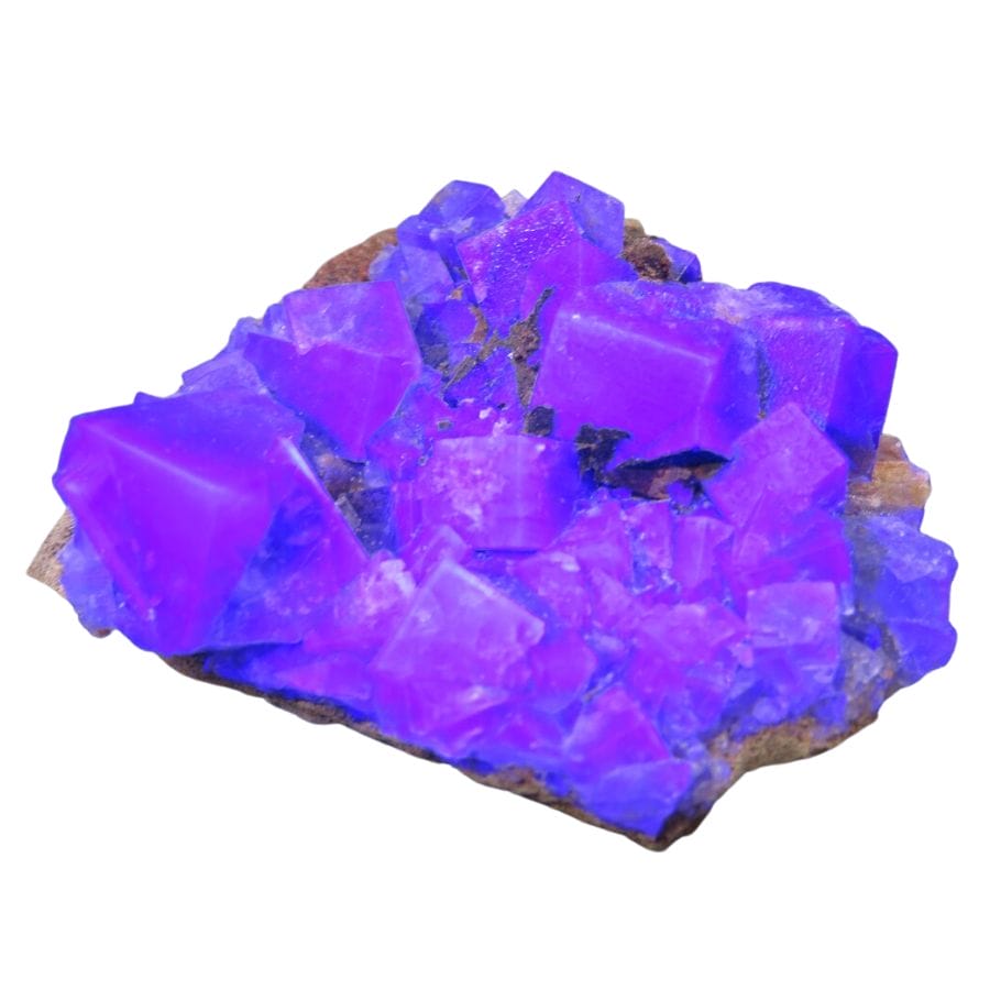 rough fluorescent crystals glowing purple under UV light