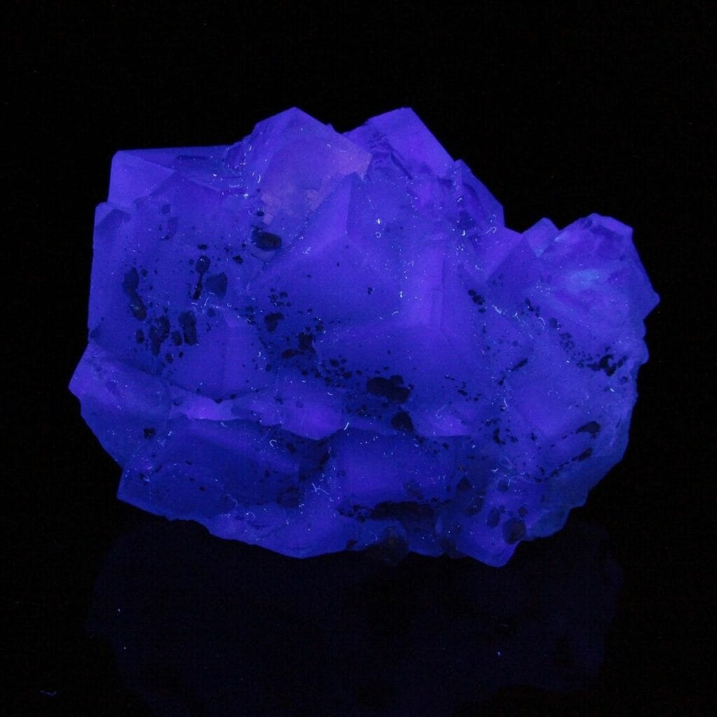 fluorite crystals glowing blue under UV light