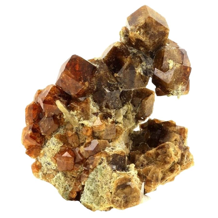 rough orange garnet crystals on a rock