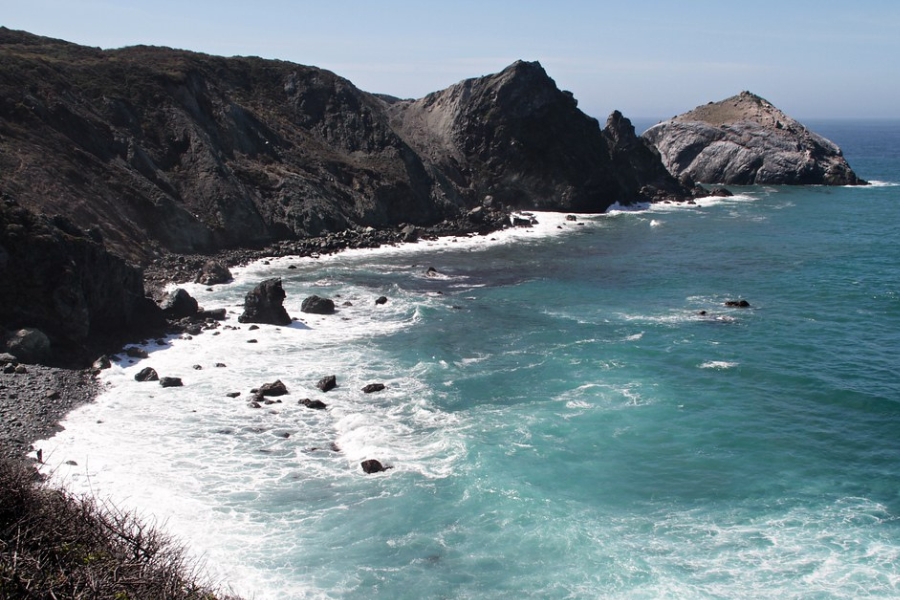 A beautiful scenery at the Cape San Martin with flowing waves on the rocky shore