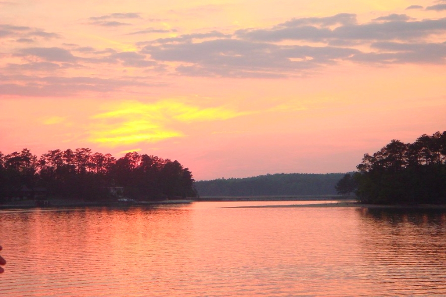 Sunset view of the Lake Martin showing calm waters and peach orange sky