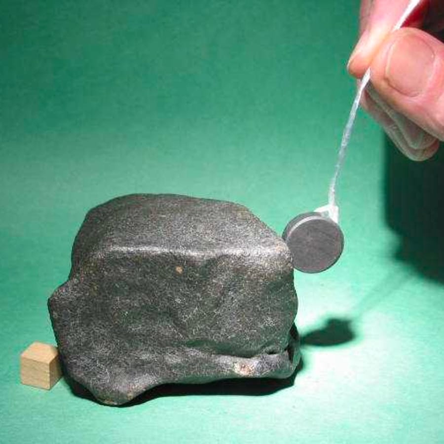 A piece of magnet attracted to a rock