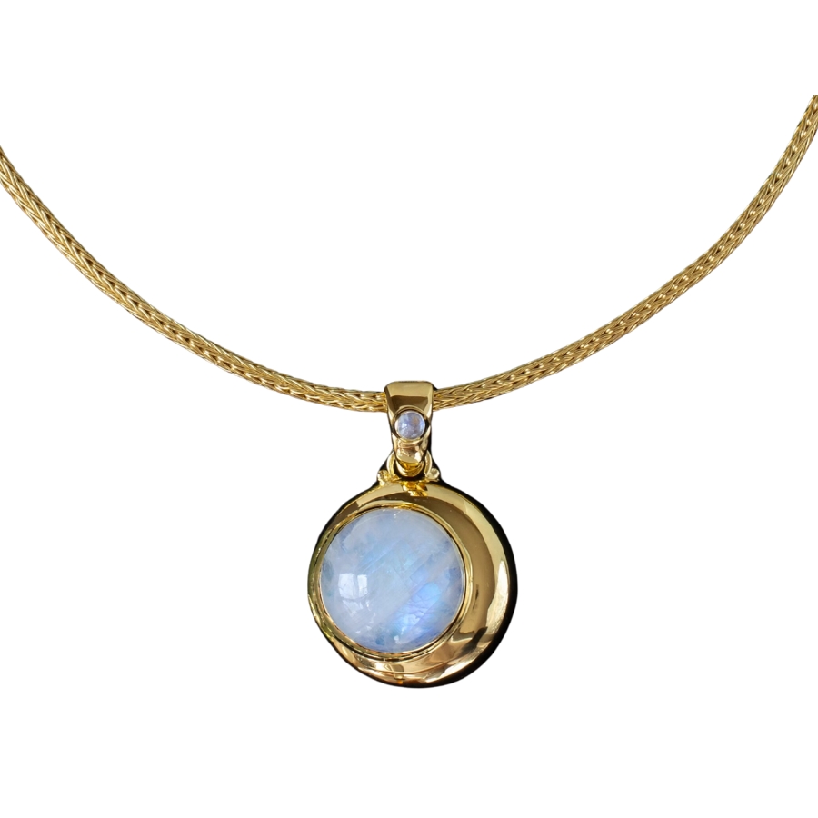 An elegant moonstone pendant necklace with a gold chain