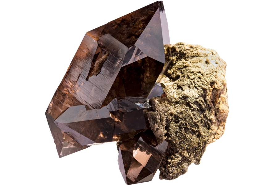 A beautiful smoky quartz crystal perched on a rock matrix