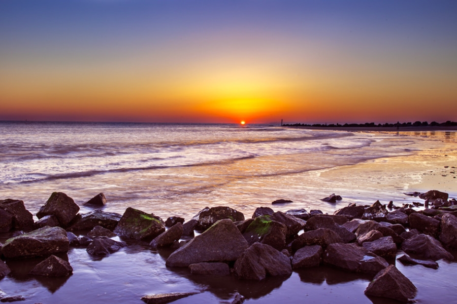 A breathtaking sunset over at Tybee Island with rocky shores