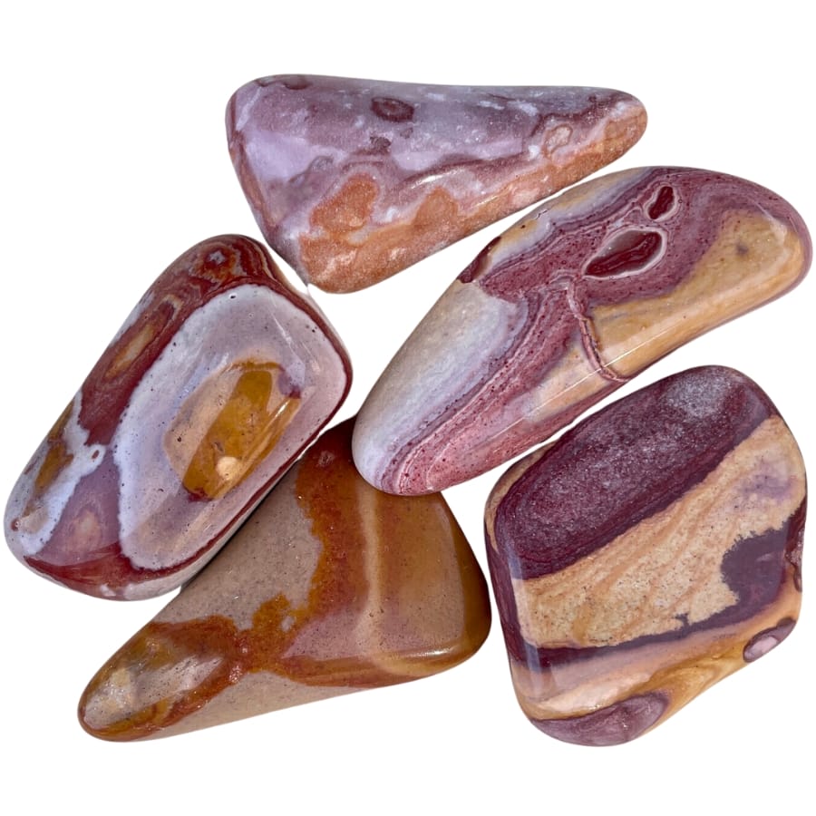 Stunning pieces of tumbled wonderstone from Nevada showing patterns of red, yellow, and brown